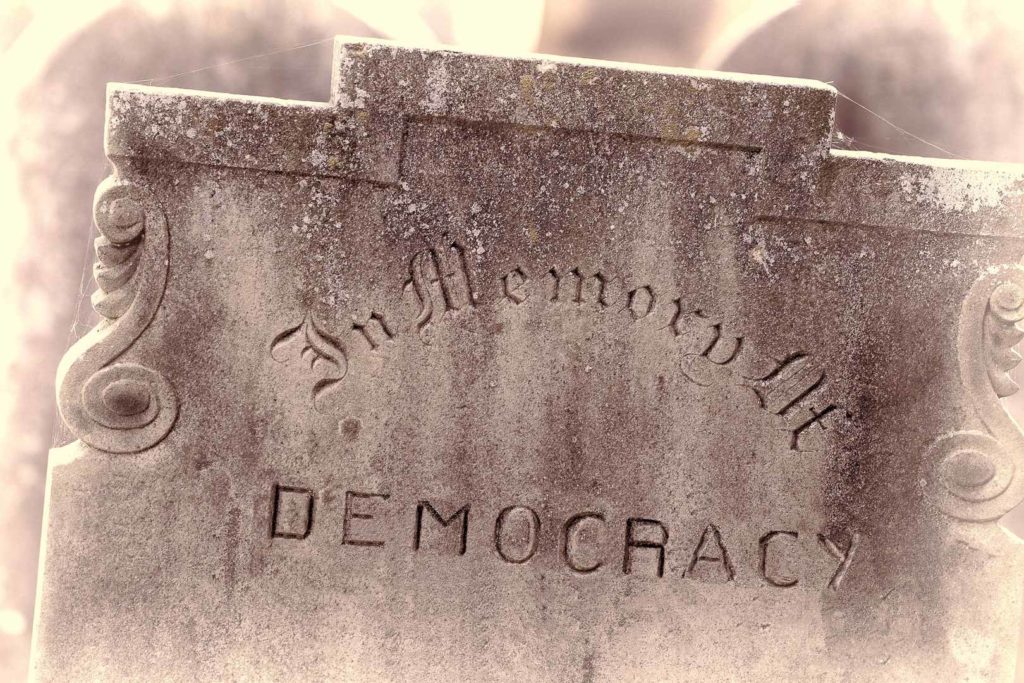 In Memory of democracy. Brexit referendum and election concept image. Gravestone with the word democracy. Political madness and modern politics gone bad.